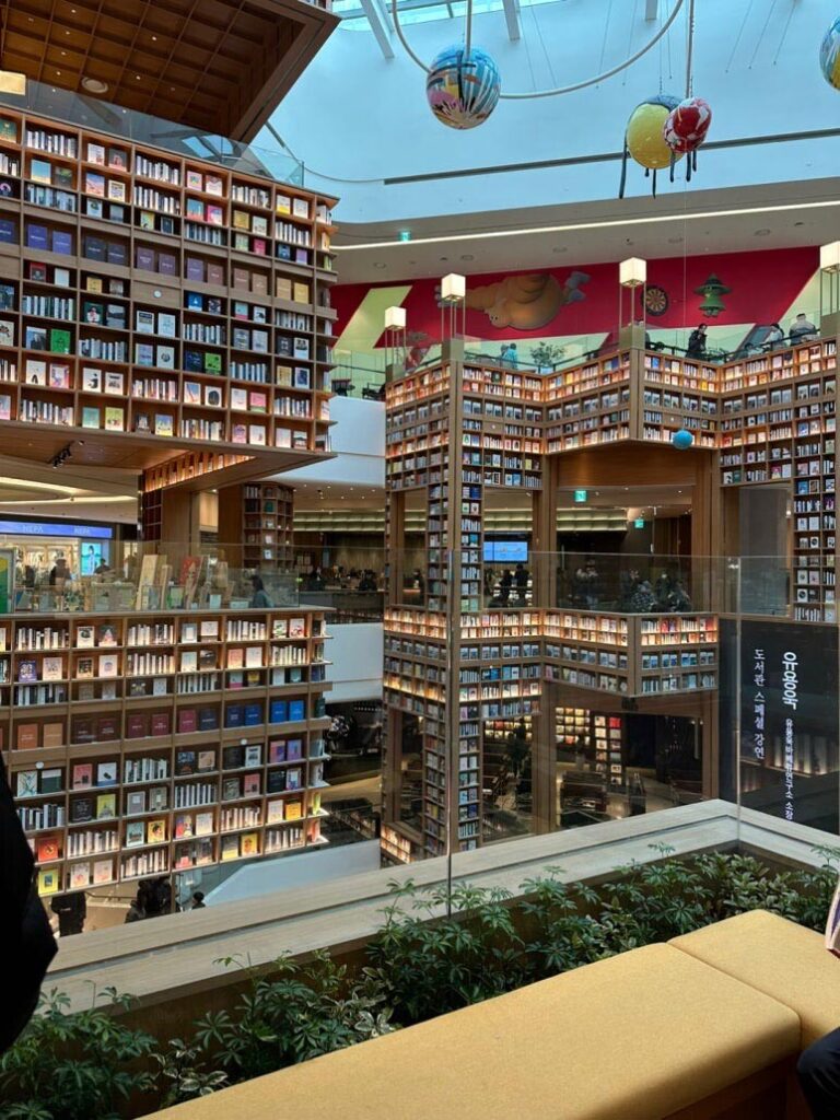 An impressive close-up of thousands of books neatly arranged on the giant wooden bookshelves at Starfield Library Suwon.