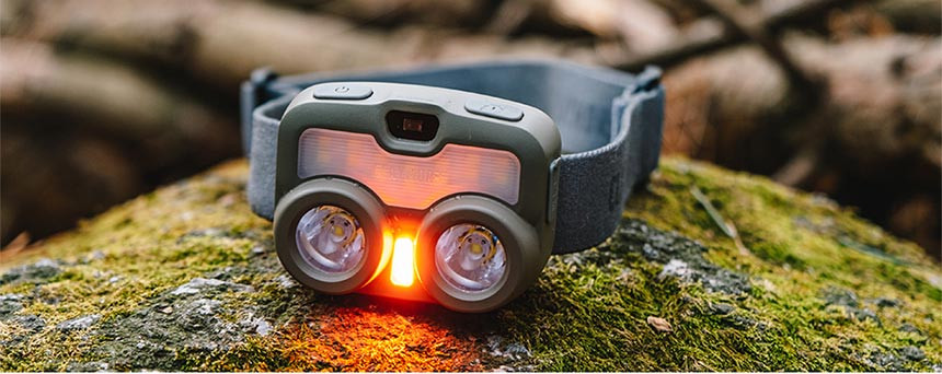 Claymore Heady 3 headlamp placed on grass for outdoor camping use