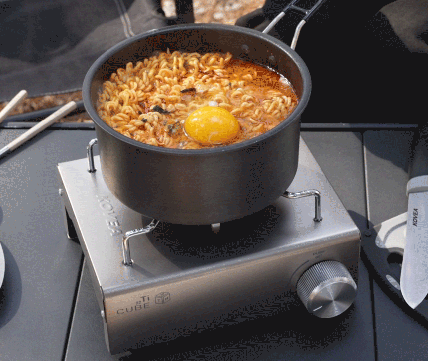 Boiling delicious Korean instant noodles (ramen) in a pot using the Kovea Titan Cube stove at a campsite.
