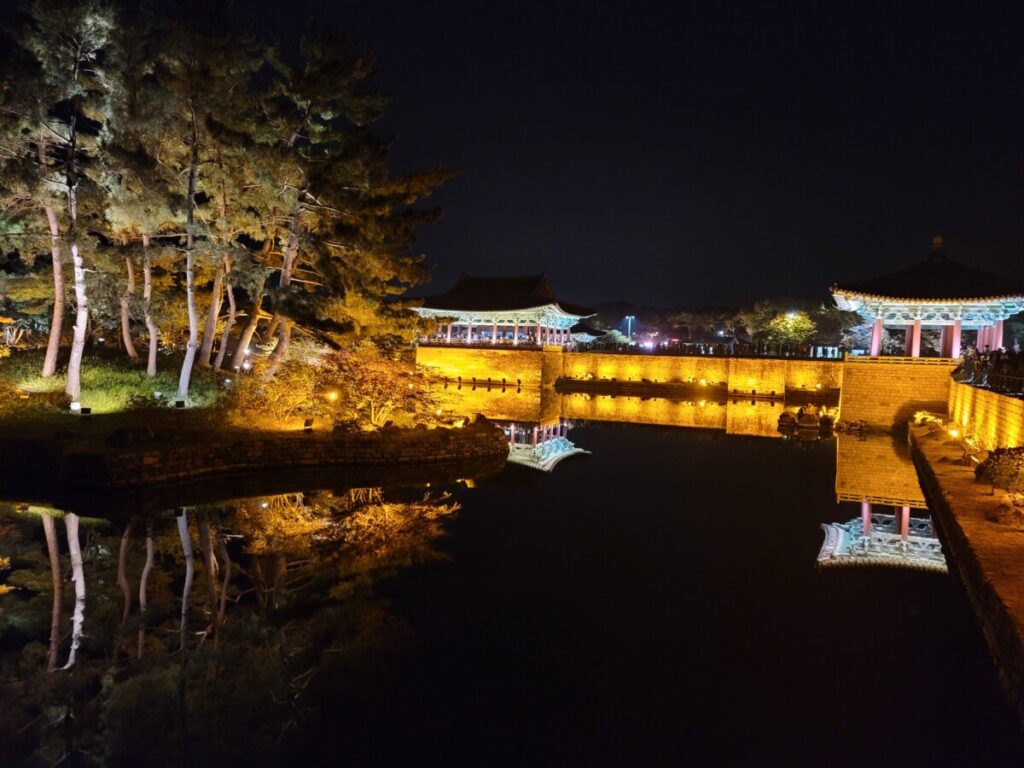 Stunning night view of the illuminated traditional Korean pavilions at Donggung Palace and Wolji Pond in Gyeongju.