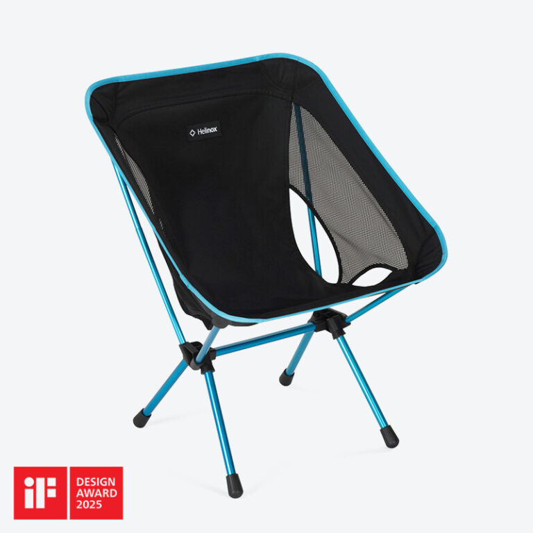 A full view of the Helinox Chair One RE, an ultralight and portable camping chair set up outdoors.