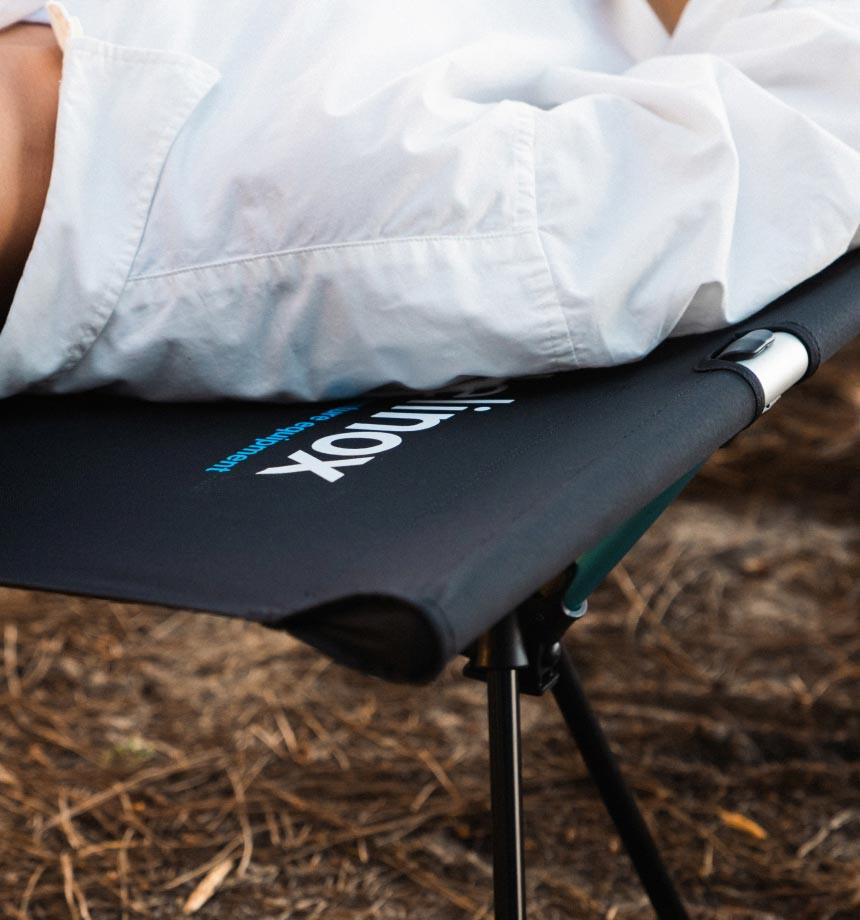 Helinox Cot One Convertible Review - camper resting comfortably on the cot outdoors