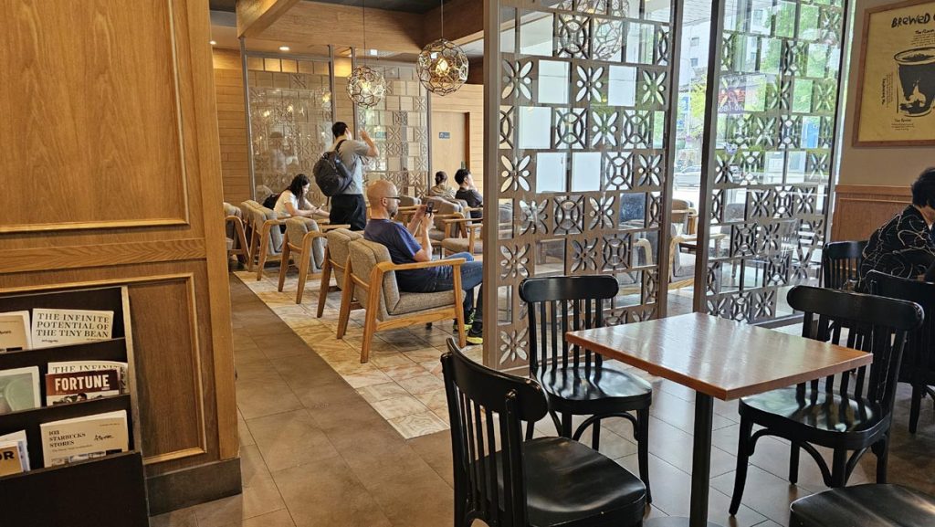 Warm and spacious Starbucks interior in Korea with stylish modern seating.