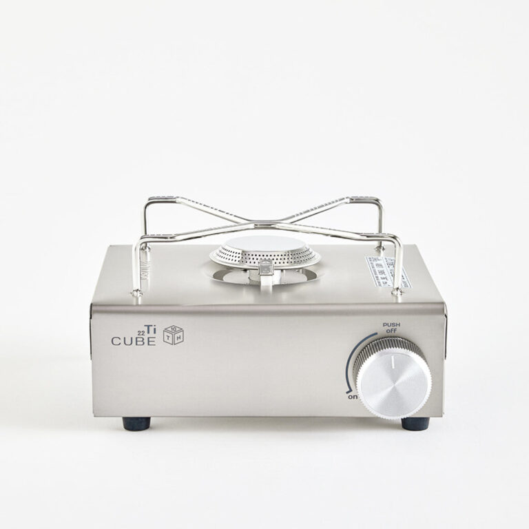 A full overview shot of the Kovea Titan Cube camping stove, showcasing its compact and premium stainless steel body design.