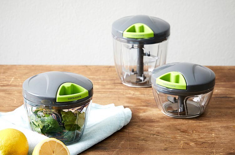 Multiple sizes of Lock and Lock vegetable slicers displayed side by side on a kitchen table.