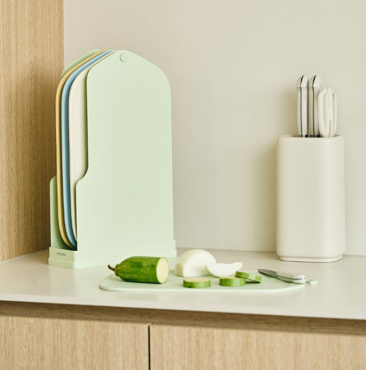 Modori Clean Cutting Board Set displayed with fresh vegetables in a stylish kitchen interior