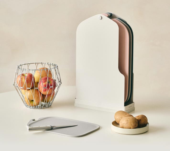 Modori Clean Cutting Board Set displayed beside bowls of prepared food on a kitchen table