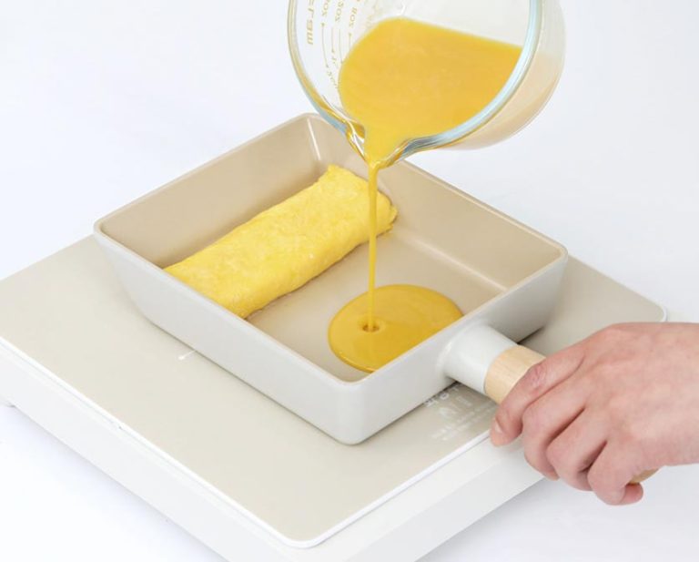 Pouring beaten eggs into the Neoflam PICA Ceramic Induction Egg Pan to make a Korean rolled omelet.