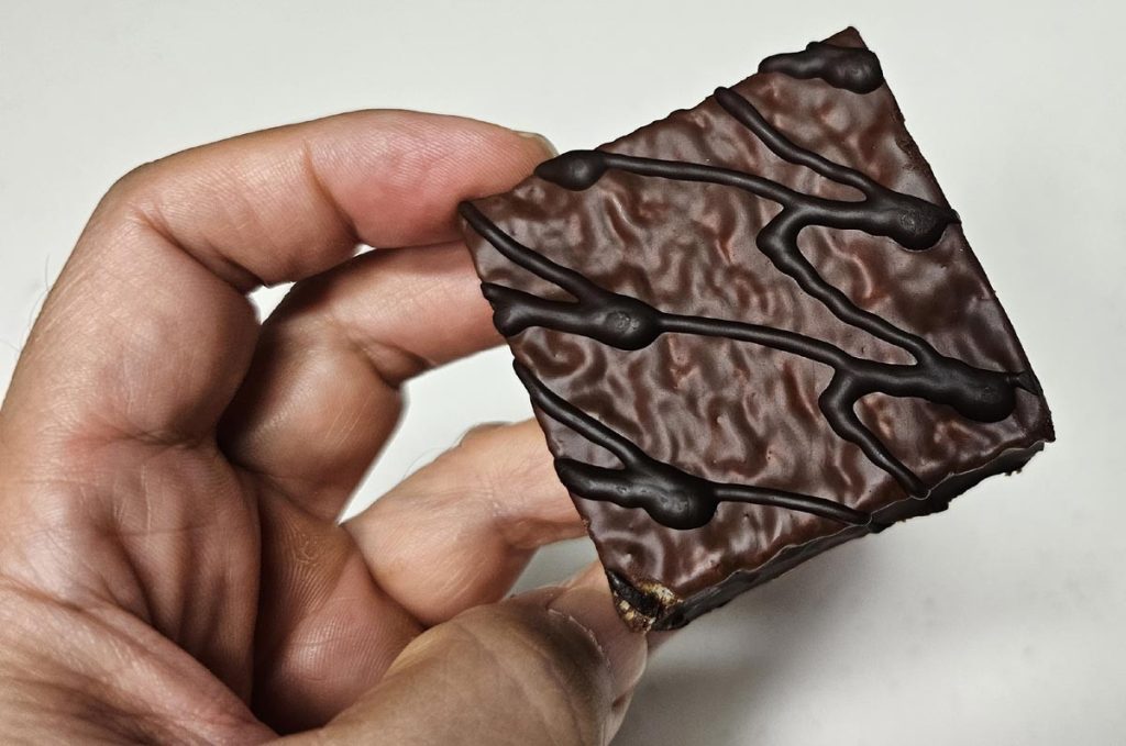 Close-up of a rectangular Haitai Oh Yes cake with chocolate coating and drizzle