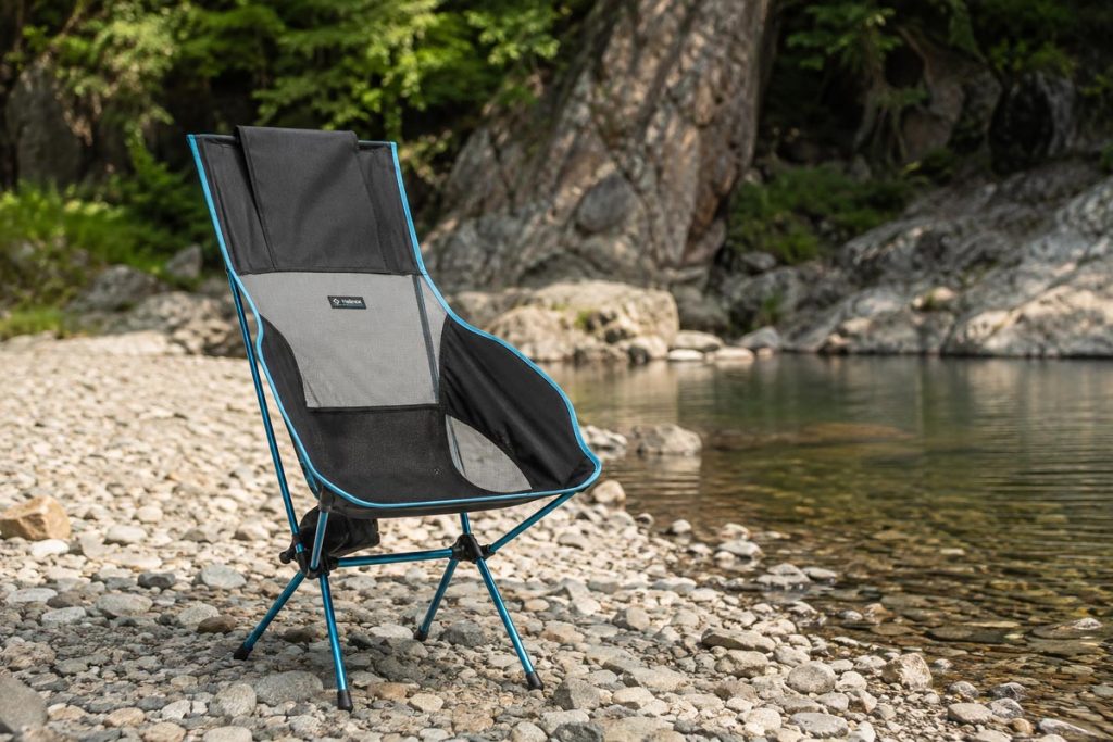 Helinox Savanna Chair set up on a rocky riverbank during a camping trip