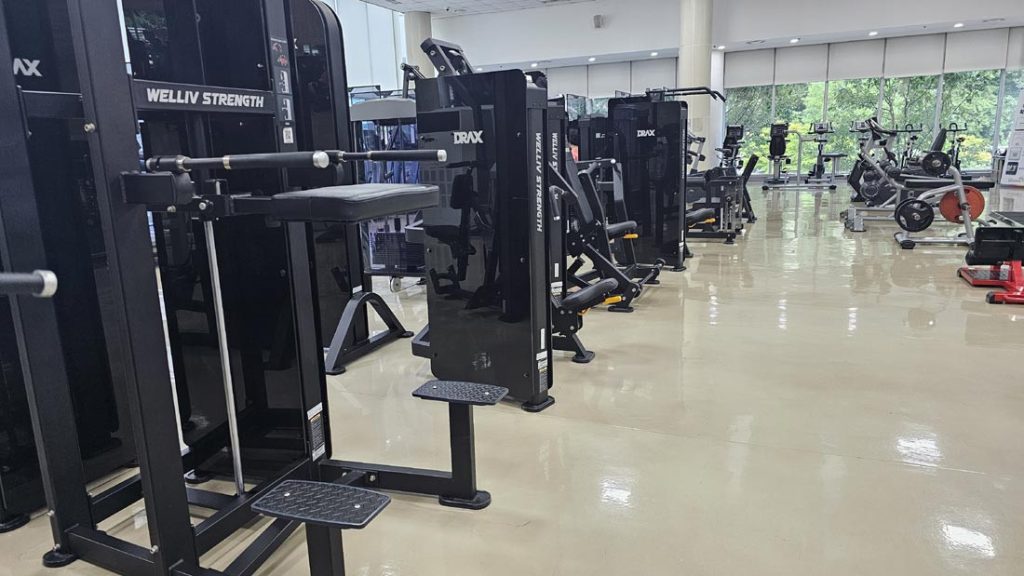 Various strength training and fitness machines inside a Korean gym