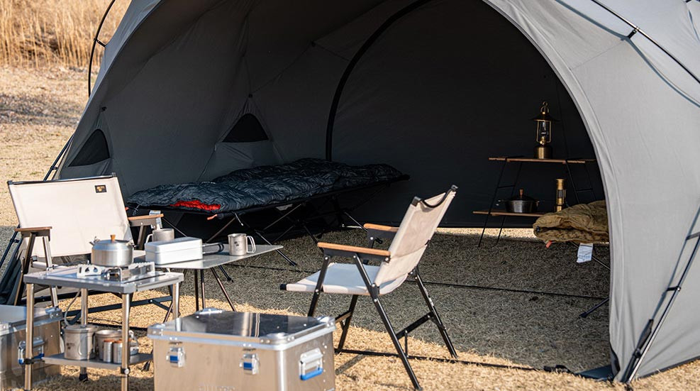 Minimal Works Shelter GHE arranged with camping furniture and outdoor gear