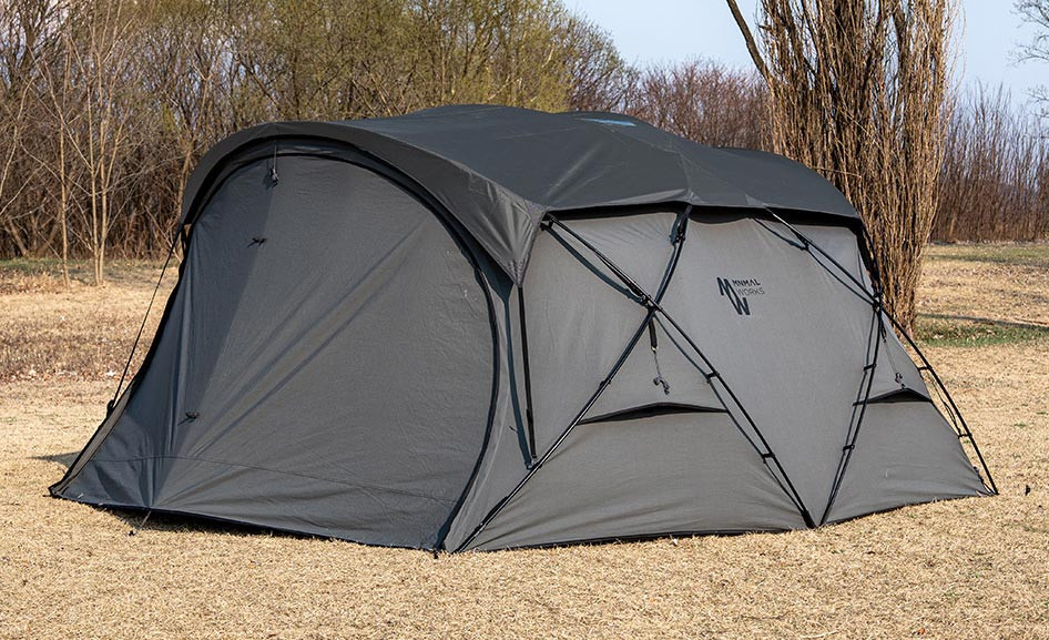 Minimal Works Shelter GHE set up on grass at an outdoor campsite
